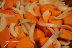 Garlic and Squash in an Oven-safe Pan with Onions Added In