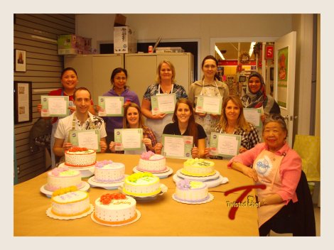 This is a picture of the whole class with our instructor. You can see all of the finished cakes and the participants with their certificates :)